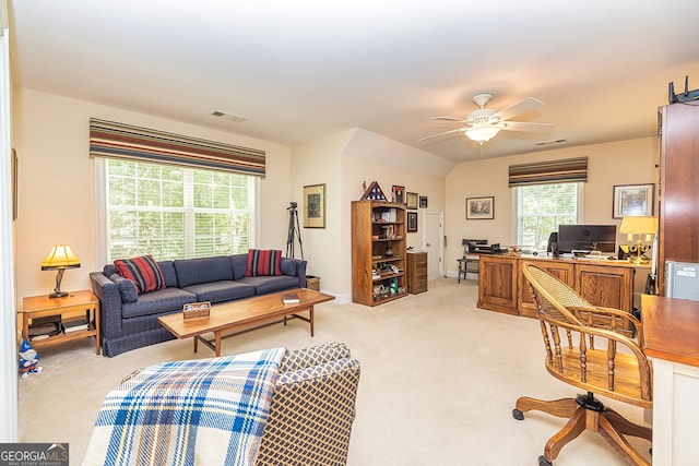 carpeted living room with ceiling fan