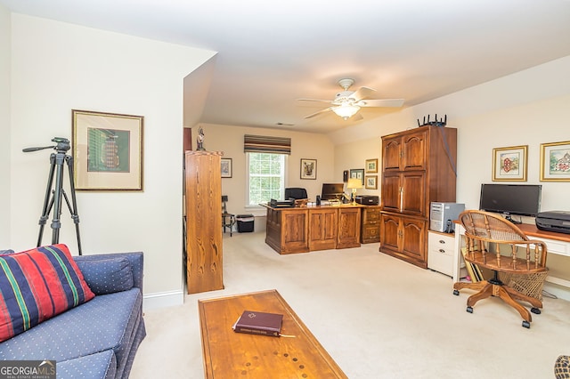 carpeted office space featuring ceiling fan