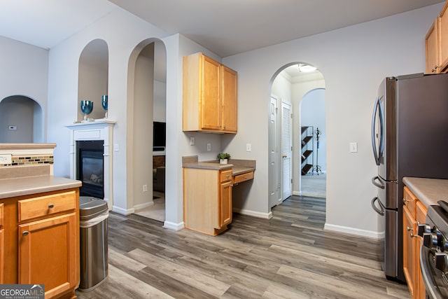 kitchen featuring wood-type flooring and stainless steel electric range oven