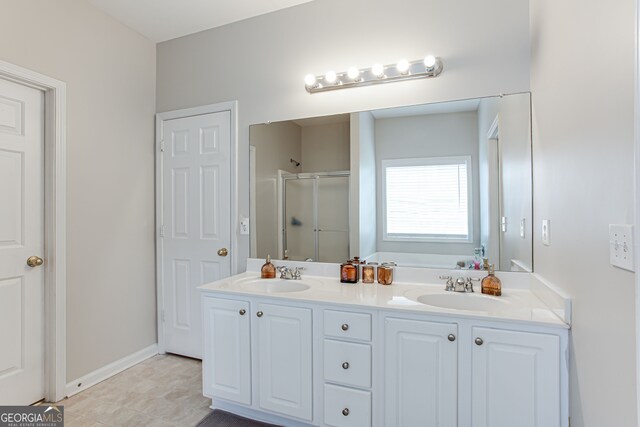 bathroom with vanity, a shower with door, and tile patterned floors