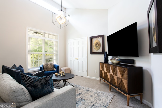 living room with carpet floors, beamed ceiling, and high vaulted ceiling