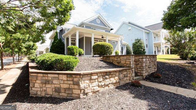 view of front of home with ceiling fan and a porch