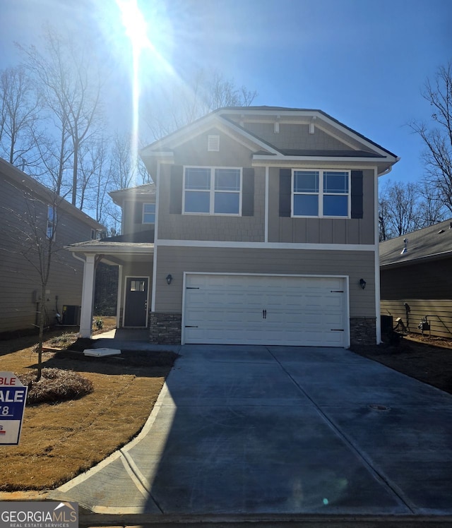 view of property featuring a garage and covered porch