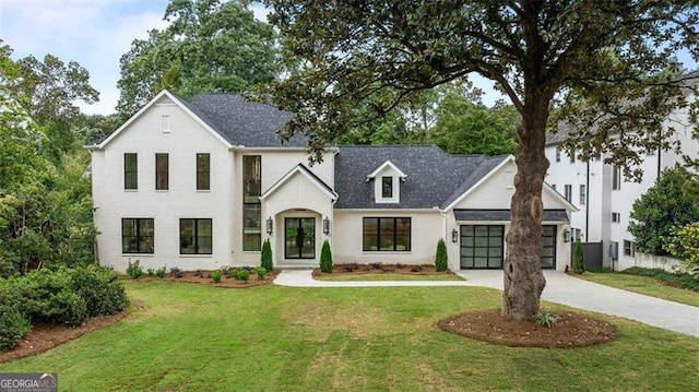 view of front of home with a garage and a front yard