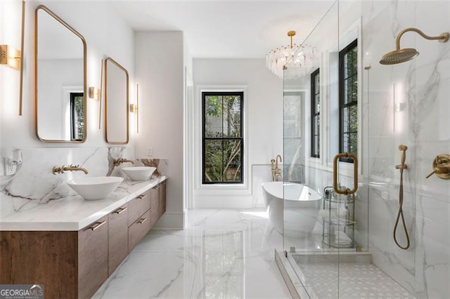 bathroom featuring independent shower and bath, tasteful backsplash, vanity, and a notable chandelier