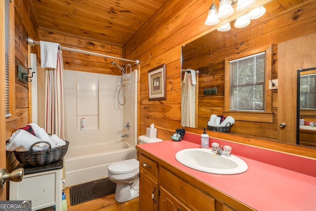 full bathroom with wood walls, shower / tub combo with curtain, vanity, and toilet