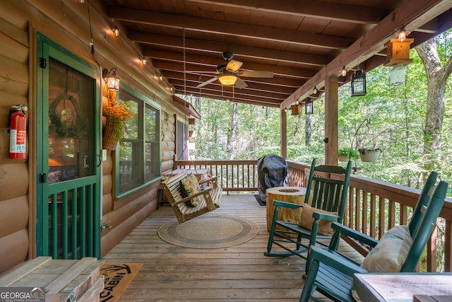 wooden deck with ceiling fan and grilling area