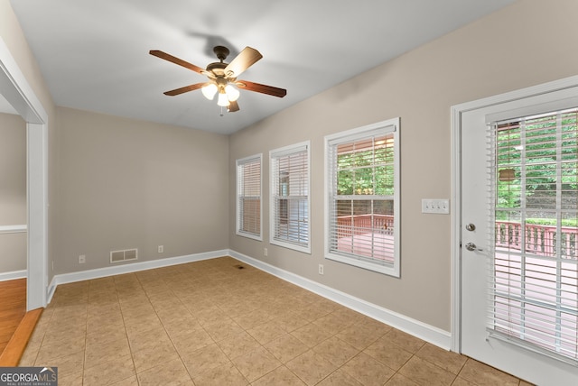 unfurnished room featuring ceiling fan and light tile patterned floors