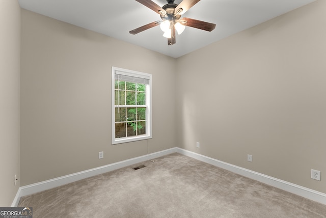 empty room with ceiling fan and light colored carpet