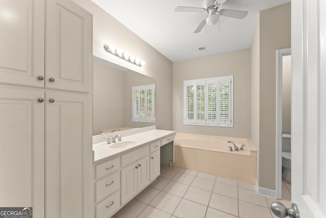 bathroom with a washtub, tile patterned floors, ceiling fan, vanity, and toilet