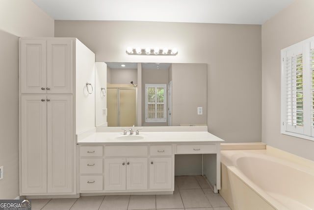 bathroom featuring vanity, separate shower and tub, tile patterned floors, and a wealth of natural light