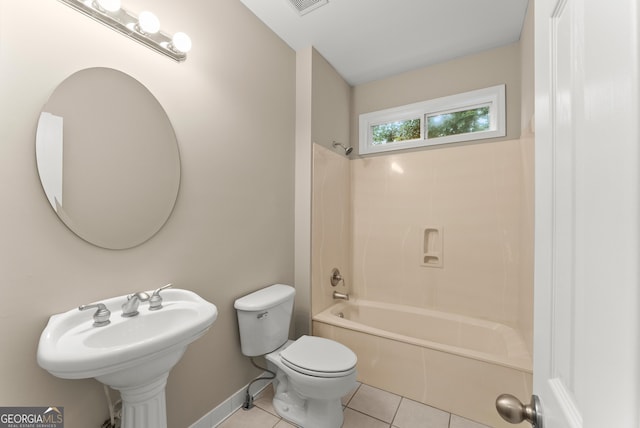 bathroom with tile patterned flooring, shower / bathtub combination, and toilet