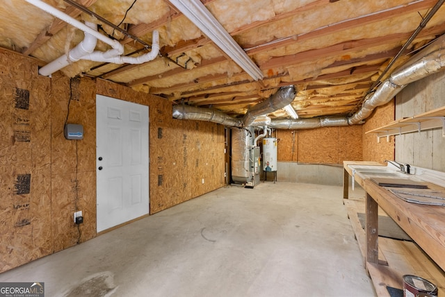 basement featuring gas water heater and sink