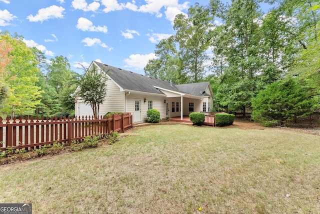 view of front of home featuring a deck and a front yard