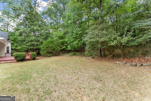 view of yard featuring a wooden deck