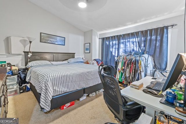 carpeted bedroom with lofted ceiling