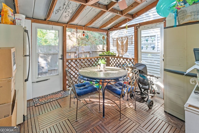 sunroom featuring vaulted ceiling