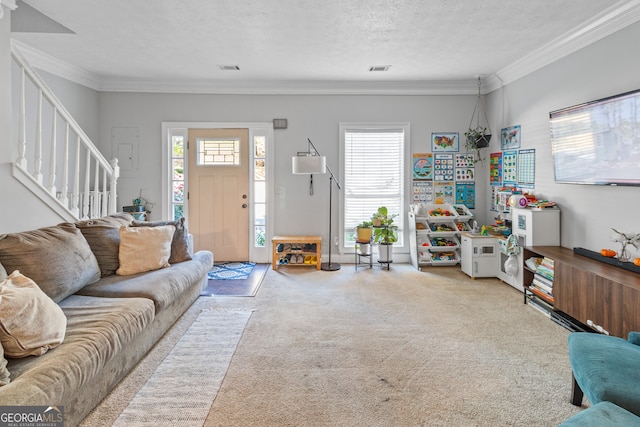 living room with ornamental molding, a textured ceiling, and light colored carpet