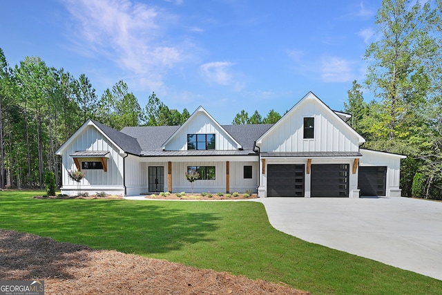 modern farmhouse style home featuring a garage, a porch, and a front yard