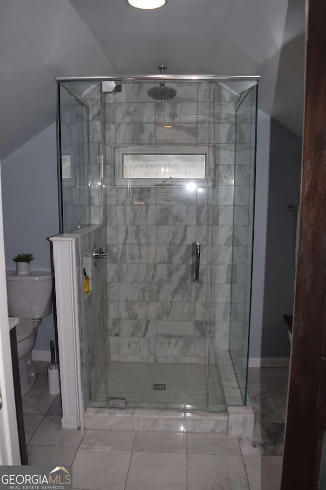 bathroom featuring walk in shower, lofted ceiling, and toilet