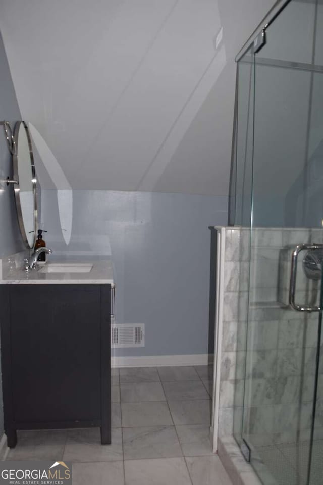 bathroom featuring walk in shower and vanity