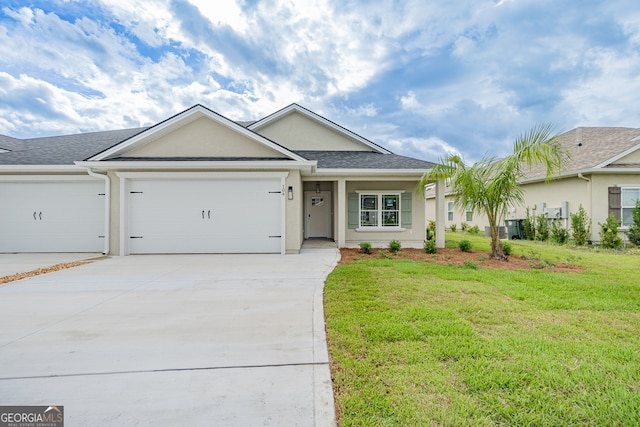 single story home featuring a garage and a front lawn