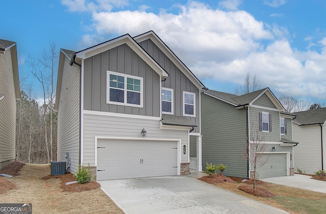 view of front of property featuring central AC and a garage