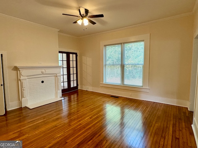 unfurnished living room featuring ceiling fan, crown molding, a healthy amount of sunlight, and dark hardwood / wood-style flooring