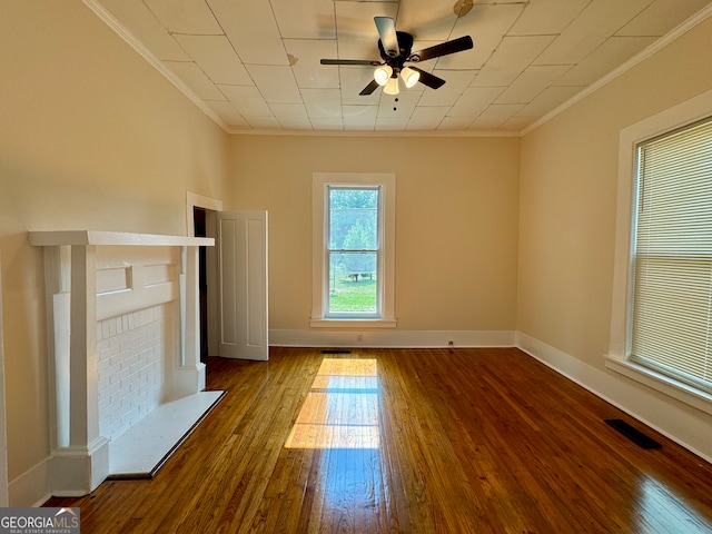 unfurnished living room with ornamental molding, wood-type flooring, and ceiling fan