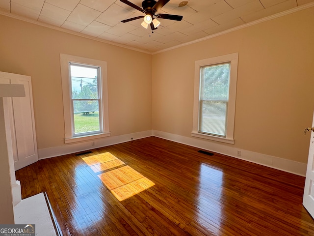 spare room featuring wood-type flooring, crown molding, and ceiling fan