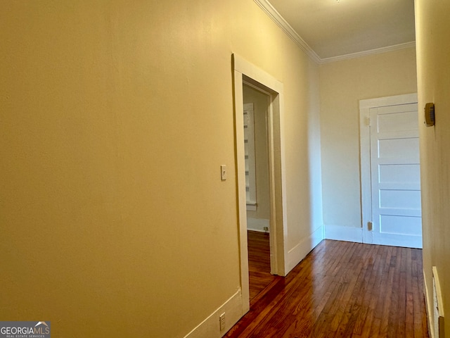 hallway with ornamental molding and dark hardwood / wood-style flooring