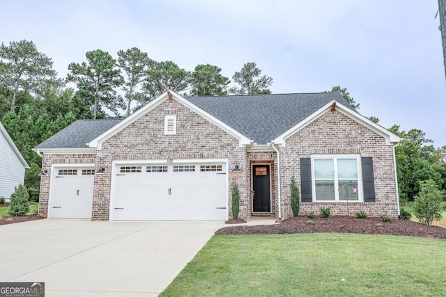 view of front of property featuring a front lawn and a garage