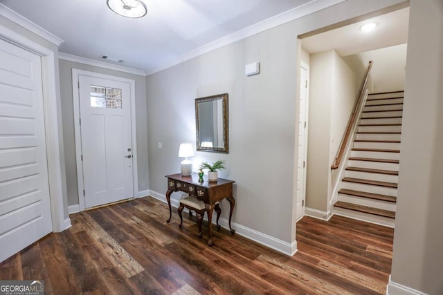 foyer entrance featuring crown molding and dark hardwood / wood-style flooring