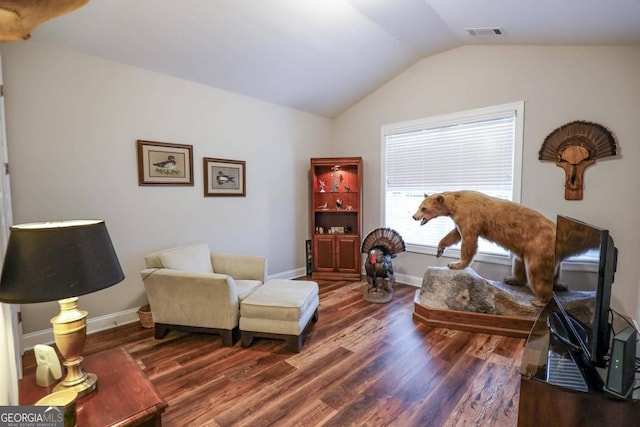 sitting room with lofted ceiling and dark hardwood / wood-style floors