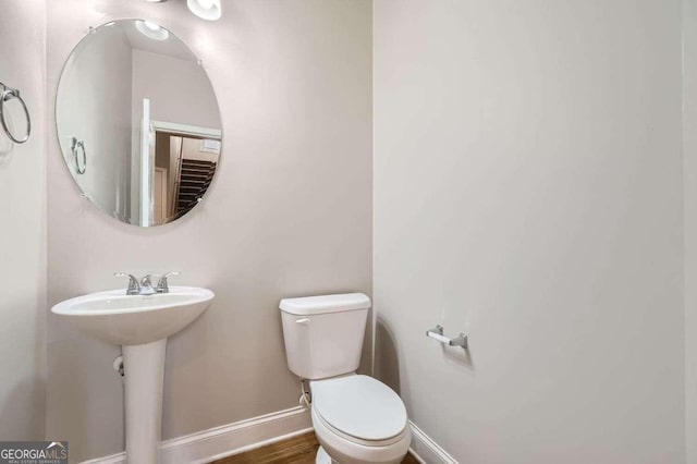 bathroom featuring hardwood / wood-style floors, toilet, and sink