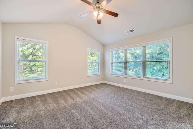 empty room with ceiling fan, carpet flooring, and vaulted ceiling