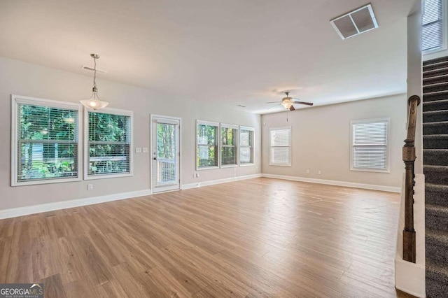 unfurnished living room featuring light hardwood / wood-style floors and ceiling fan