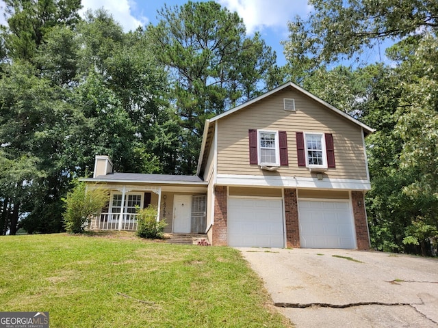 view of front of property with a front lawn, a porch, and a garage