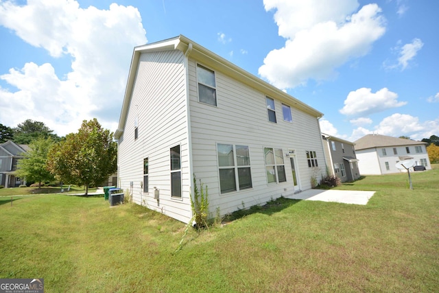 back of house featuring a lawn and central AC unit