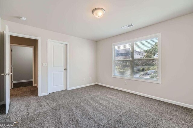 unfurnished bedroom featuring carpet flooring