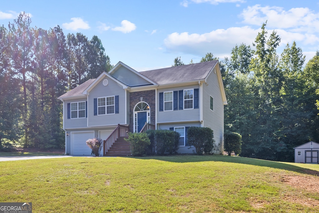 split foyer home featuring a front yard and a garage