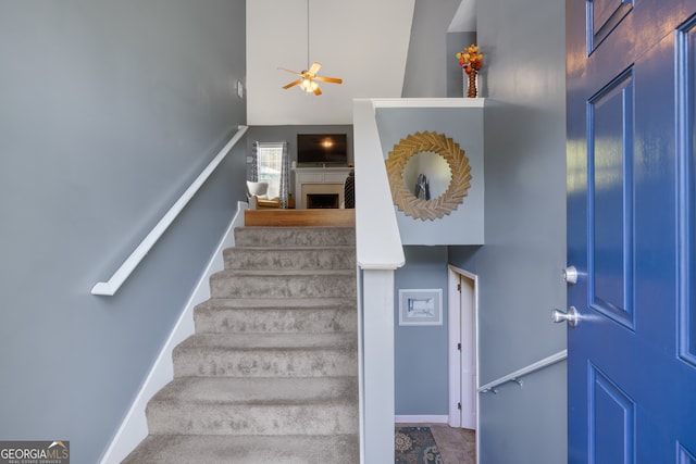 stairs with high vaulted ceiling and ceiling fan