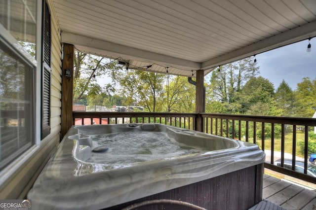 wooden deck featuring a hot tub