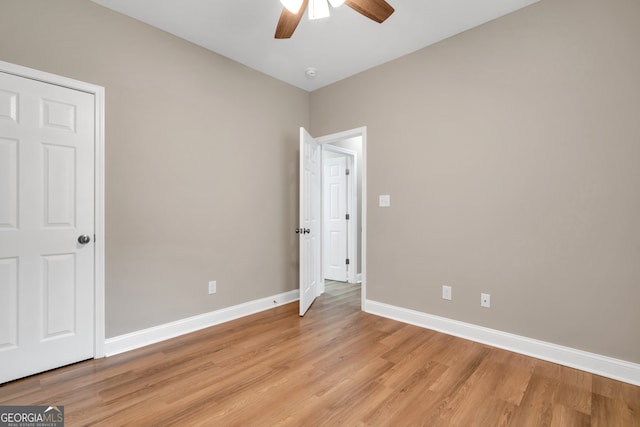 spare room featuring ceiling fan and light hardwood / wood-style flooring