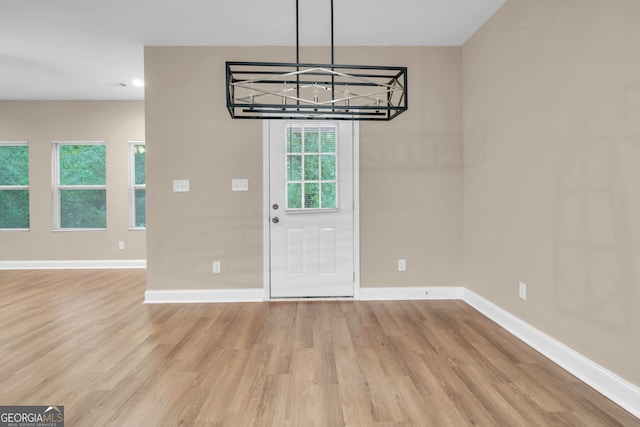 entrance foyer featuring a notable chandelier and light hardwood / wood-style floors