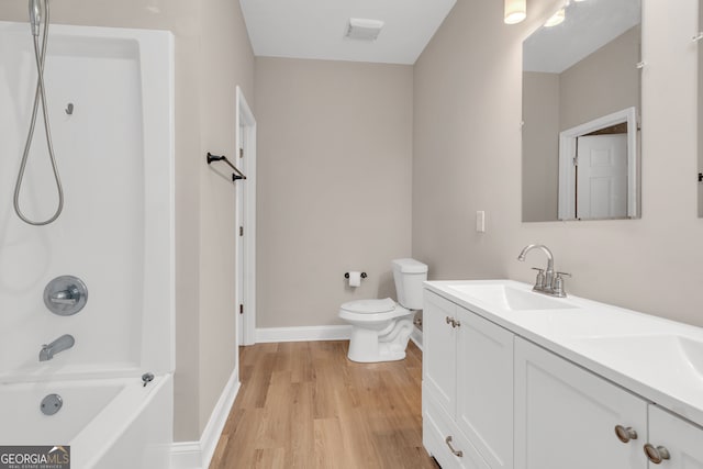 full bathroom with shower / bathtub combination, vanity, toilet, and hardwood / wood-style flooring