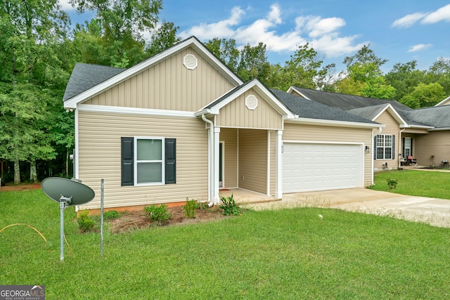 view of front of property featuring a front lawn and a garage