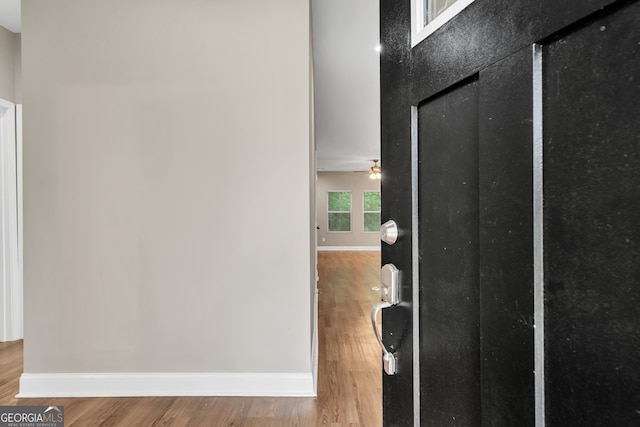 hallway with wood-type flooring