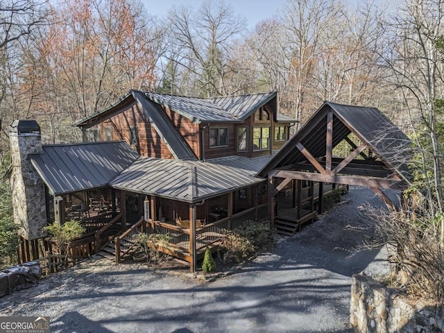 112 N Hiawatha Trl, Blue Ridge, GA 30513 - view of front facade featuring metal roof, a standing seam roof, a chimney, and a porch