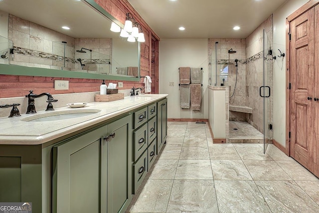 bathroom with double vanity, a stall shower, a sink, and recessed lighting